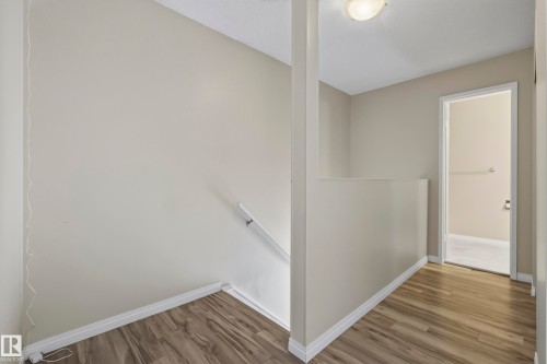 Wood-finish flooring throughout, neutral wall tones, and overhead lighting - 141 Dickinsfield Court Nw, Edmonton, AB 