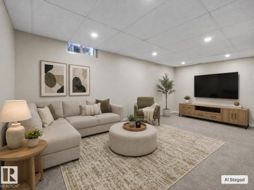 Recessed lighting illuminates this versatile living space featuring a drop ceiling, neutral wall tones, and soft carpet flooring - 141 Dickinsfield Court Nw, Edmonton, AB 