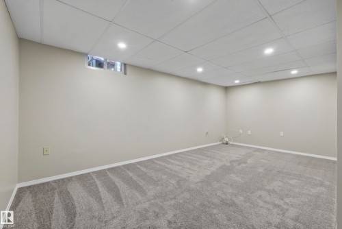 Recessed lighting, drop ceiling, neutral wall paint, gray carpeting, and a small transom window - 141 Dickinsfield Court Nw, Edmonton, AB 
