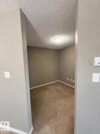 Carpeted room with neutral wall paint and a flush-mount ceiling light - 