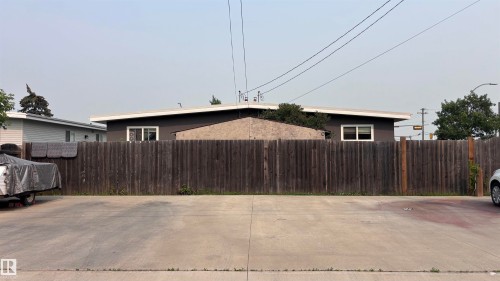 Paved surface with a wood privacy fence - 7604 7606 75 Street Nw, Edmonton, AB - Outdoor