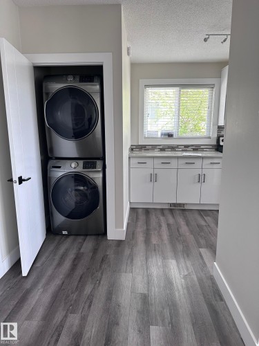 Integrated laundry nook with stacked units - 7604 7606 75 Street Nw, Edmonton, AB - Indoor Photo Showing Laundry Room