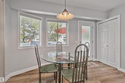 Wood-finish flooring, white paneled doors, and a frosted glass-panel door - 18812 89 Avenue Nw, Edmonton, AB 