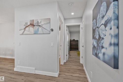 Wood-finish flooring with white baseboards, recessed ceiling lighting, and a neutral wall color - 18812 89 Avenue Nw, Edmonton, AB 