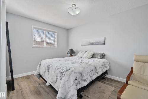 Wood-finish flooring, white walls, and a window with horizontal blinds - 18812 89 Avenue Nw, Edmonton, AB 