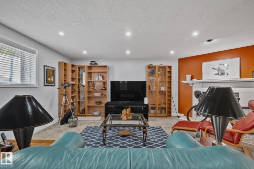Recessed ceiling lighting, built-in shelving, white mantel, and window with horizontal blinds - 18812 89 Avenue Nw, Edmonton, AB 