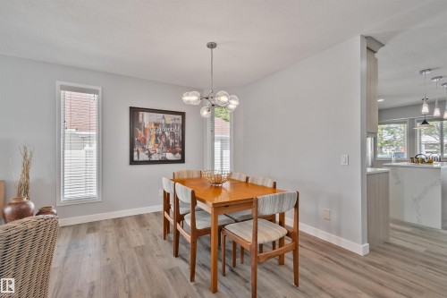 Wood-finish flooring, recessed lighting, and a modern chandelier - 18812 89 Avenue Nw, Edmonton, AB 