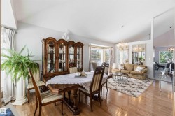 Hardwood flooring throughout, vaulted ceilings, bay window, and chandelier lighting - 