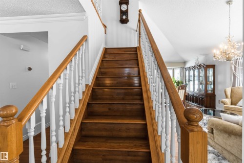 Hardwood staircase with painted white balusters and wood handrails - 522 Klarvatten Lake Wynd Nw, Edmonton, AB 
