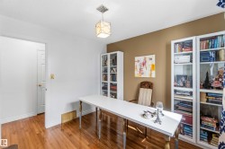 Wood-finish flooring, recessed lighting, and built-in glass-front cabinetry - 