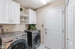 White paneled cabinetry, light neutral wall color, and a flush-mount ceiling light fixture - 