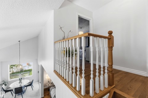 Upper landing with wood-finish flooring and white walls - 522 Klarvatten Lake Wynd Nw, Edmonton, AB 