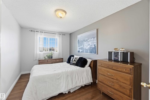 Window with white casing, wood-finish flooring, and neutral wall paint - 522 Klarvatten Lake Wynd Nw, Edmonton, AB 