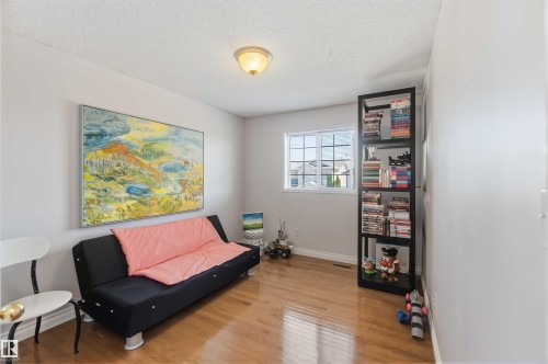 Hardwood-finish flooring, a multi-pane window, and a built-in shelving unit - 522 Klarvatten Lake Wynd Nw, Edmonton, AB 