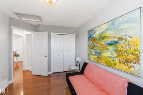 Wood-finish flooring with white trim and paneled doors - 522 Klarvatten Lake Wynd Nw, Edmonton, AB 