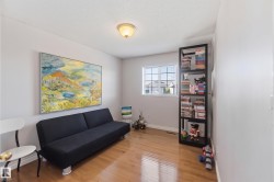 Recessed lighting, wood-finish flooring, and a large window with grid panes - 