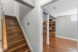 Hardwood staircase with natural wood handrail - 