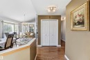 High ceilings, wood-finish flooring, white paneled bifold doors, and recessed lighting fixtures - 522 Klarvatten Lake Wynd Nw, Edmonton, AB 