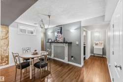 Hardwood-finish flooring, built-in decorative fireplace with mantel, recessed window, white baseboards, and white paneled doors - 