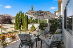 Private deck with lattice fencing, mature privacy landscaping, and a garden fountain - 
