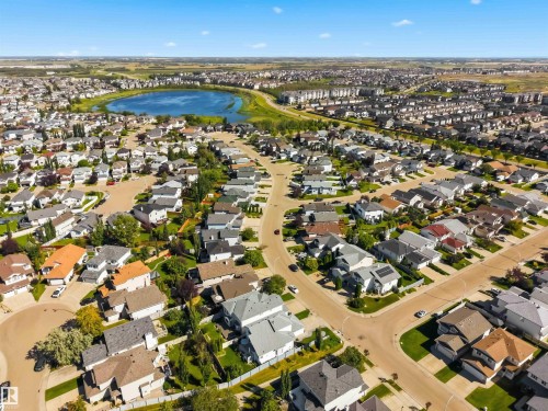 Residential neighborhood with a central lake and surrounding green spaces - 522 Klarvatten Lake Wynd Nw, Edmonton, AB 