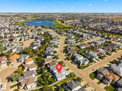 Aerial perspective of a residential neighborhood with a prominent body of water - 