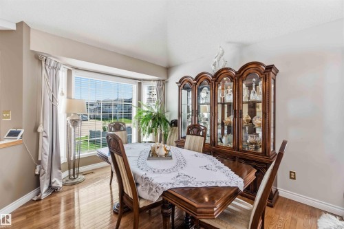 Wood-finish flooring with a multi-pane bay window - 522 Klarvatten Lake Wynd Nw, Edmonton, AB 