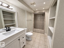 White vanity with integrated sink, black-finish faucet, and coordinating hardware - 