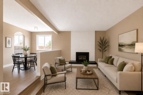 Living area with wood-finish flooring, a white brick fireplace, and large windows - 10439 36A Ave Nw, Edmonton, AB 