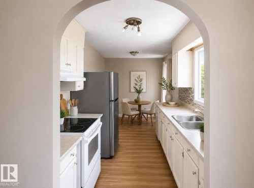Arched entry to the kitchen featuring wood-finish flooring, white cabinetry, a double basin stainless steel sink, and a multi-tone tile backsplash - 10439 36A Ave Nw, Edmonton, AB 