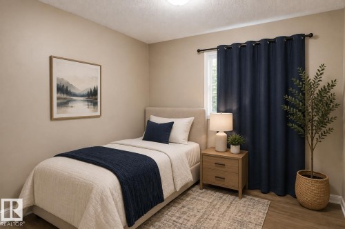 Comfortable bedroom featuring hardwood flooring, a wood-finish nightstand with integrated lighting, blackout curtains, and a decorative area rug - 10439 36A Ave Nw, Edmonton, AB 