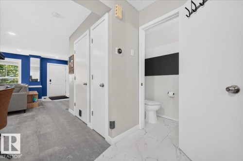 Wood-finish flooring throughout the main living area - 1217 76 Street Sw, Edmonton, AB 