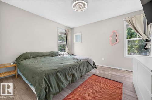 Wood-finish flooring, white walls, and a ceiling-mounted light fixture - 1217 76 Street Sw, Edmonton, AB 