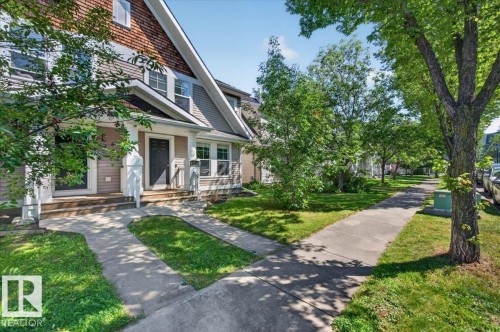 Multi-level facade with a gabled roof and dormer windows, featuring a covered porch entry - 1217 76 Street Sw, Edmonton, AB 