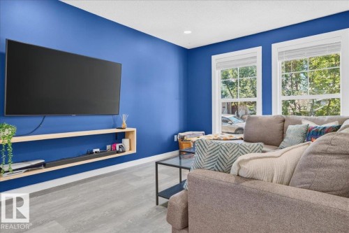 Wood-finish flooring, recessed lighting, and dual pane windows - 1217 76 Street Sw, Edmonton, AB 