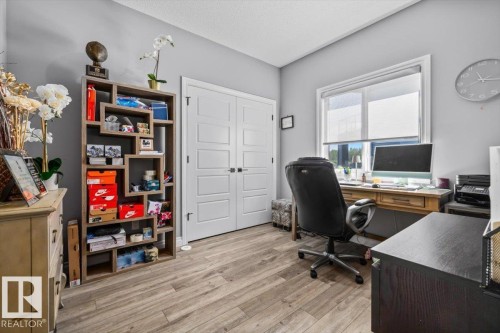 Room featuring wood-finish flooring, light grey walls, and a white ceiling - 5203 23A Avenue Sw, Edmonton, AB - Indoor Photo Showing Office
