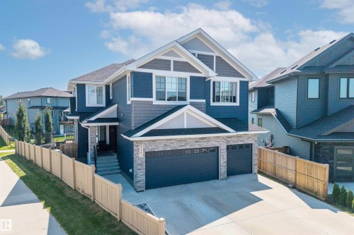 Modern two-story residence featuring blue siding and stone veneer accents - 5203 23A Avenue Sw, Edmonton, AB - Outdoor