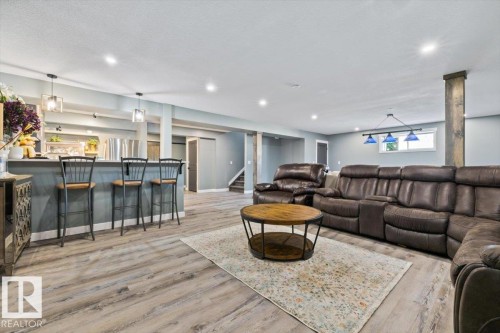 Spacious lower level featuring wood-finish flooring and recessed lighting - 5203 23A Avenue Sw, Edmonton, AB - Indoor