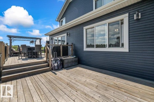 Expansive wood deck with multiple levels, featuring a pergola-covered dining area - 5203 23A Avenue Sw, Edmonton, AB - Outdoor With Deck Patio Veranda
