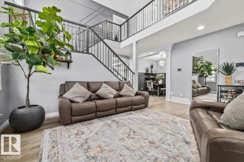 Two-story living area featuring a vaulted ceiling and an open-concept design - 5203 23A Avenue Sw, Edmonton, AB - Indoor Photo Showing Living Room