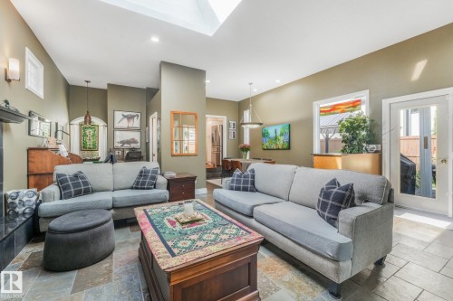 Skylight with recessed lighting, Brazilian slate flooring, wall sconces, a glass-paneled exterior door. - 10531 137 Street Nw, Edmonton, AB 