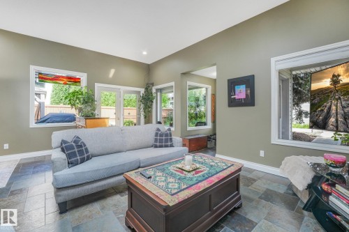 Vaulted ceiling with recessed lighting, large pane windows, glass French doors, and slate tile flooring - 10531 137 Street Nw, Edmonton, AB 