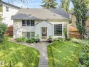 Traditional residential exterior featuring light-colored siding, and multiple large windows - 10531 137 Street Nw, Edmonton, AB 