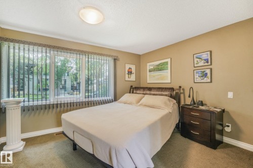 Large window with vertical blinds, ceiling-mounted light fixture - 10531 137 Street Nw, Edmonton, AB 