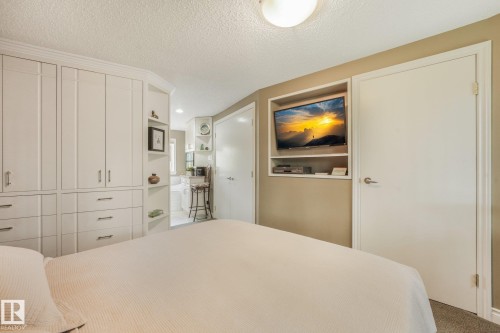 Built-in cabinetry with modern hardware, integrated media niche, and recessed shelving - 10531 137 Street Nw, Edmonton, AB 