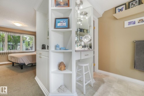 Built-in shelving unit with an integrated vanity, recessed lighting, and a full-length mirror - 10531 137 Street Nw, Edmonton, AB 