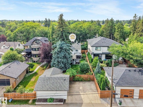 Expansive lot with mature trees and established landscaping, detached garage with paved driveway, and private fenced yard - 10531 137 Street Nw, Edmonton, AB 