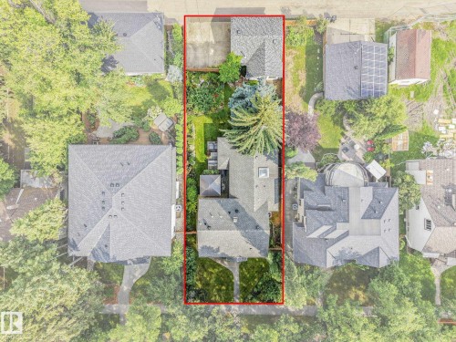 Expansive lot featuring mature trees, a detached garage, and a manicured lawn - 10531 137 Street Nw, Edmonton, AB 