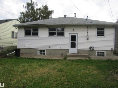 White horizontal siding exterior with multiple windows and a rear entry door - 9512 63 Avenue Nw, Edmonton, AB 