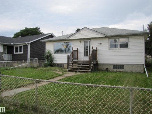White siding exterior with a pitched roof - 9512 63 Avenue Nw, Edmonton, AB 